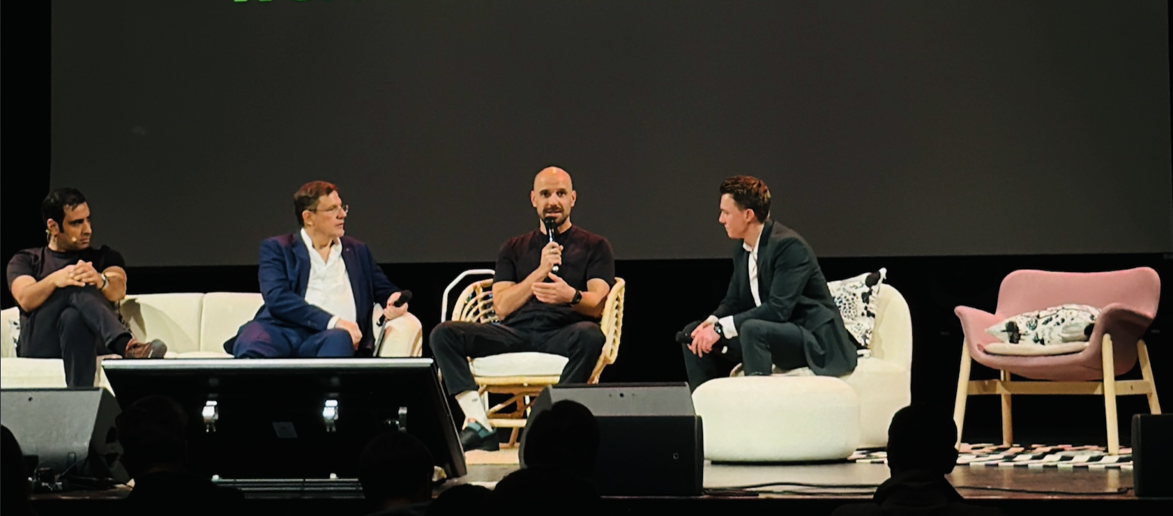 Johnny speaking alongside three panelists at the dcyphr AI conference